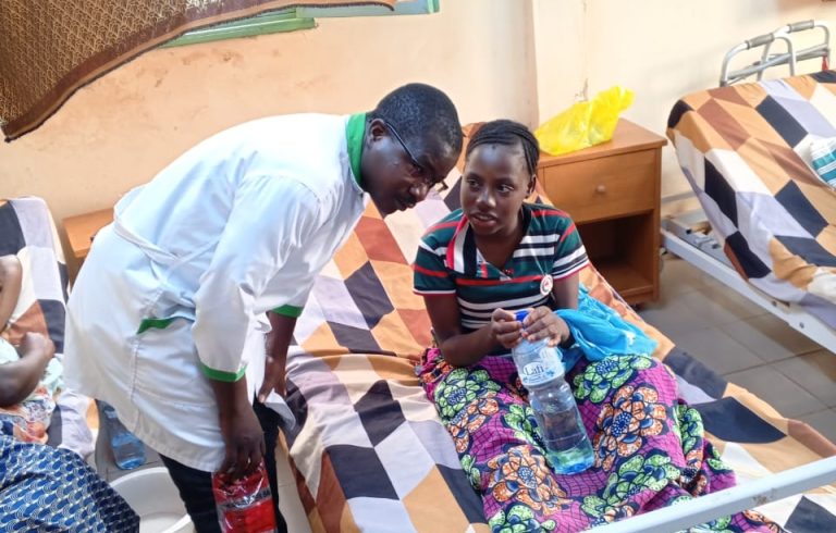 Our head nurse listening to patient in the ward