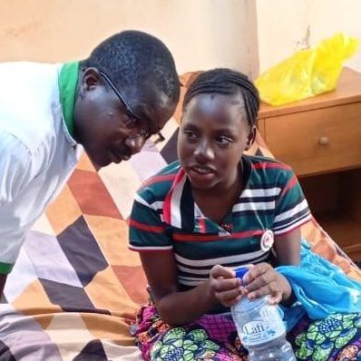 Our head nurse listening to patient in the ward